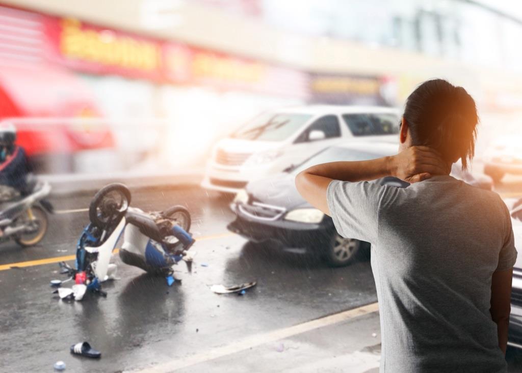 Driver woman suffering from neck pain after having a car crash and traffic collision, Slippery road in the city.