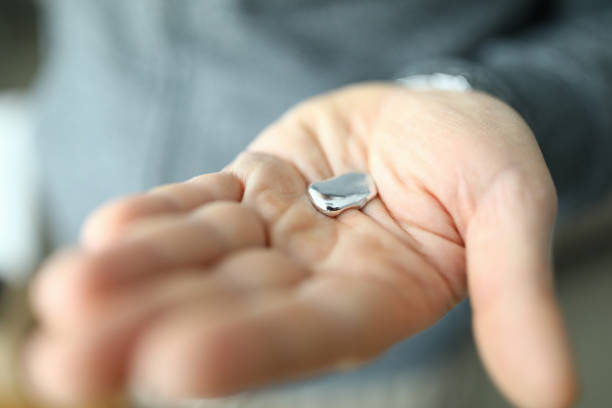 Mercury lies on male palm, chemical poisoning. Hazardous chemical element. Presence and content heavy metals in environment. There is an excess heavy metals in body. Allergy and immunity reduction